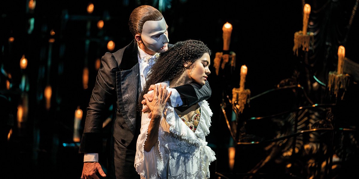 Killian Donnelly as The Phantom and Lucy St Louis as Christine, both in dramatic poses, with dark costumes.