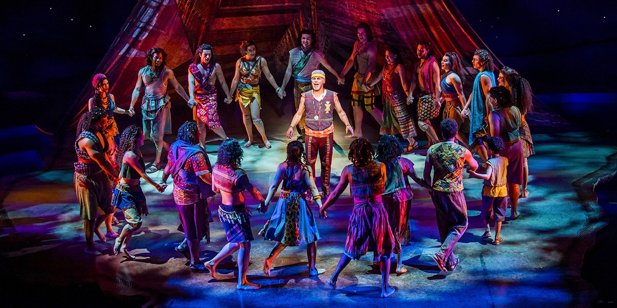 Gary Wilmot performing in a scene from The Prince of Egypt, wearing a vibrant costume on stage.