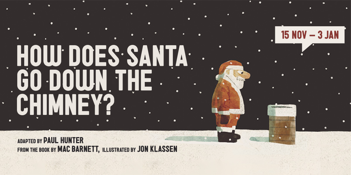 Santa Claus in a red suit and hat, smiling, holding a sack of gifts beside a chimney.