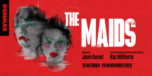 Two maids in blue uniforms cleaning a bright, tidy room with wooden floors and white walls.